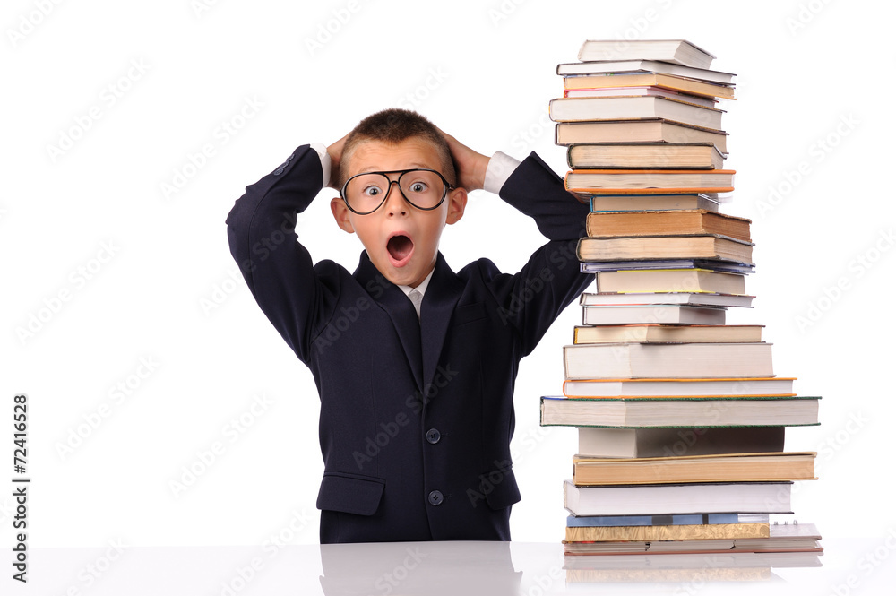 Schoolboy screaming near the huge stack of books Schoolboy screaming near the huge stack of books