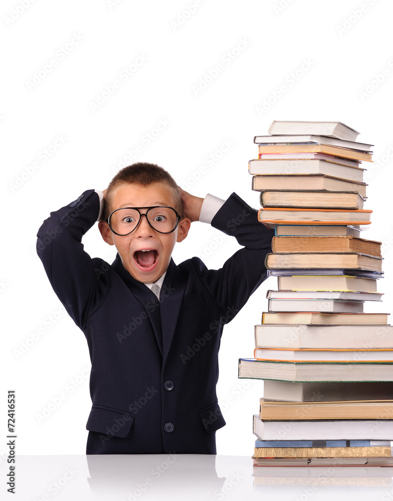 Schoolboy screaming near the huge stack of books Schoolboy screaming near the huge stack of books