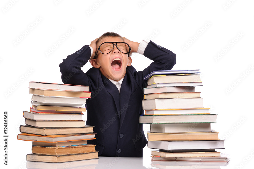 Schoolboy screaming near the huge stack of books Schoolboy screaming near the huge stack of books