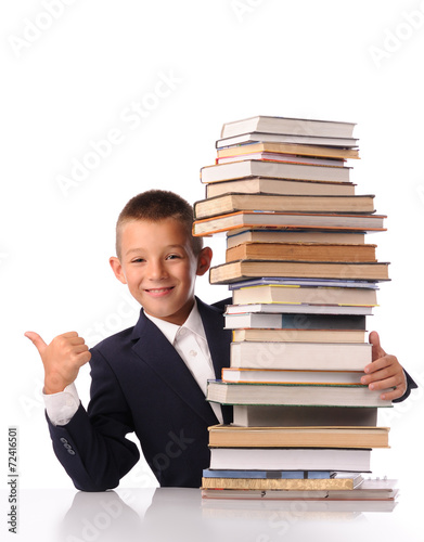 Schoolboy with huge stack of books