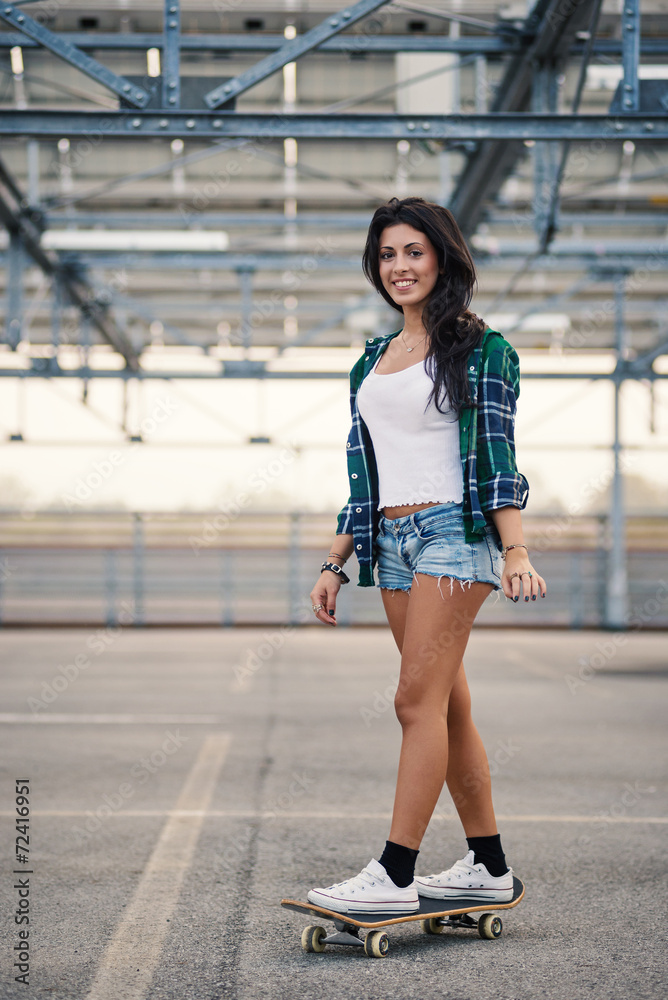 Happy teenager riding skateboard portrait outdoors in a parking Happy teenager riding skateboard portrait outdoors in a parking
