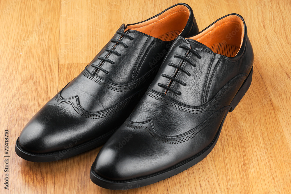 Classic men's shoes stand on the wooden floor Classic men's shoes stand on the wooden floor
