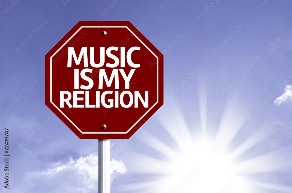 Music Is My Religion written on red road sign Music Is My Religion written on red road sign