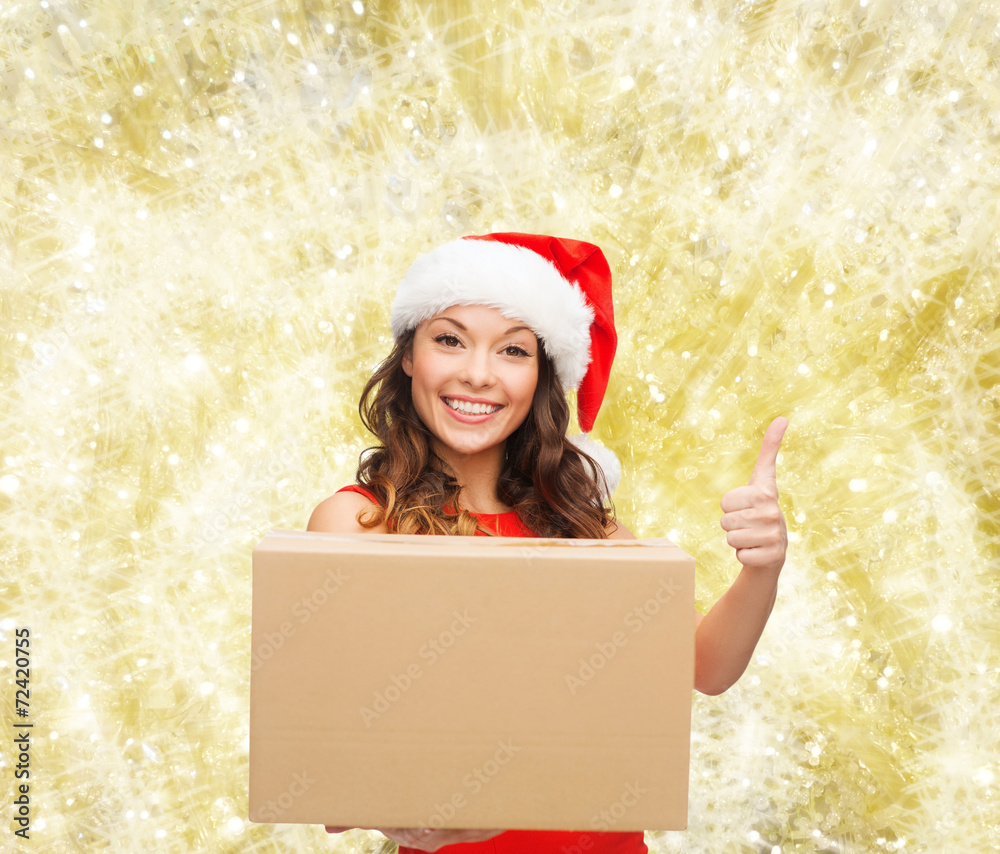 smiling woman in santa helper hat with parcel box smiling woman in santa helper hat with parcel box