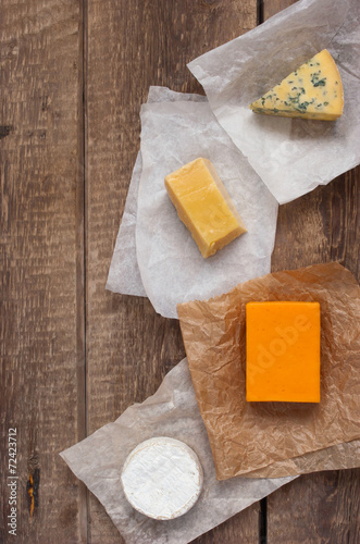 Assorted cheeses on the wooden table photo