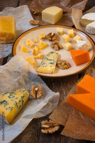 Assorted cheeses on the wooden table photo