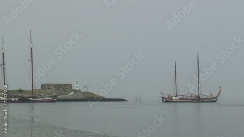 Historic freight ship is sailing north of Den Oever photo