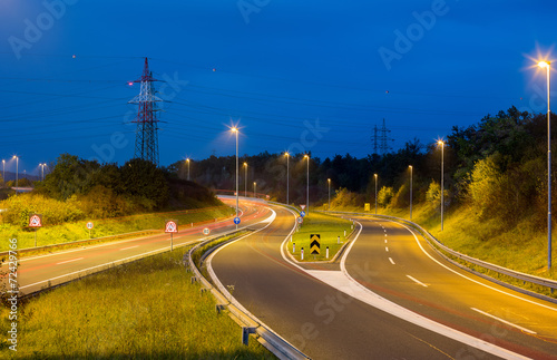 Empty hoghway and electricty pole photo