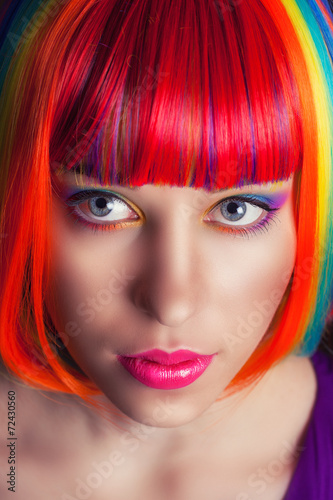 portrait of a beautiful woman wearing colorful wig
