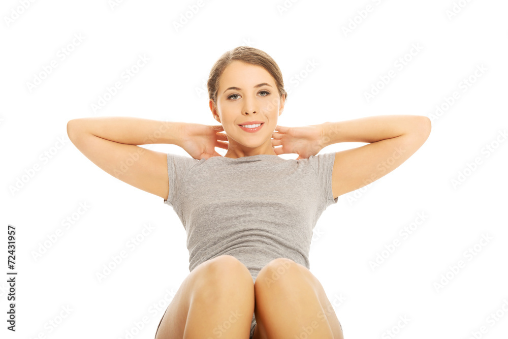 Fototapeta premium Woman exercising crunches