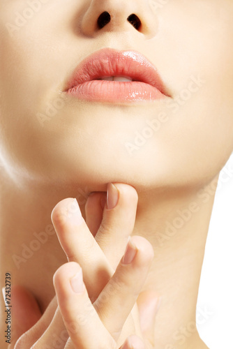 Close up of a woman touching her neck