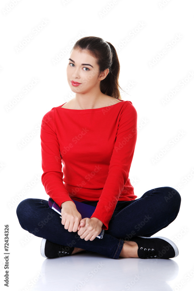 Young woman sitting cross legged Young woman sitting cross legged