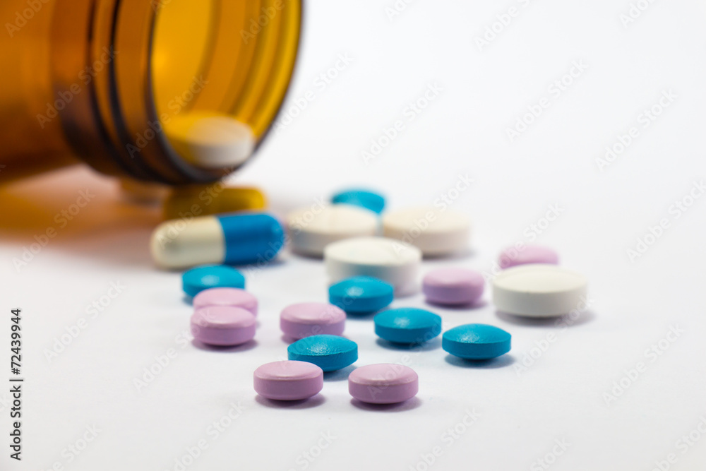 Diferent tablets pills heap mix on white isolated background Diferent tablets pills heap mix on white isolated background