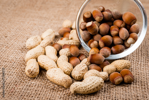 close up of nuts on glass bowl and burlap