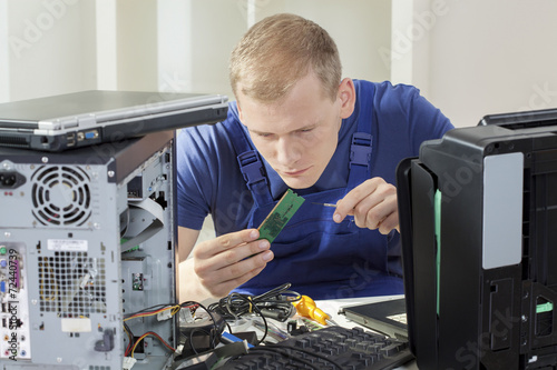 IT specialist installing ram memory