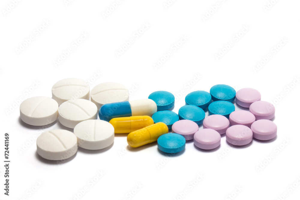 Diferent tablets pills heap mix on white isolated background Diferent tablets pills heap mix on white isolated background