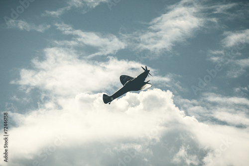 Fighter plane on cloudy sky