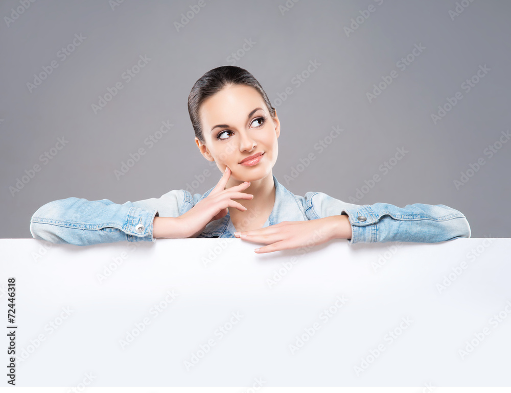 Young and beautiful teenage girl holding a blank banner Young and beautiful teenage girl holding a blank banner