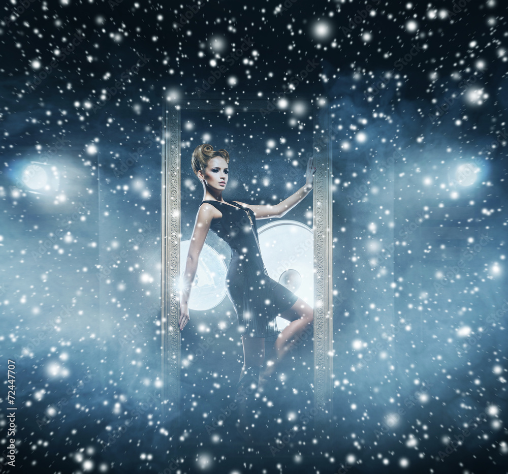 Young and emotional woman in fashion dress over snowy background Young and emotional woman in fashion dress over snowy background