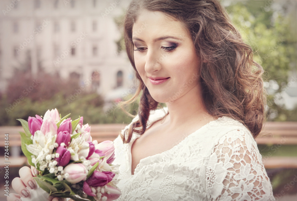 Beautiful bride smiling, holding wedding bouquet Beautiful bride smiling, holding wedding bouquet