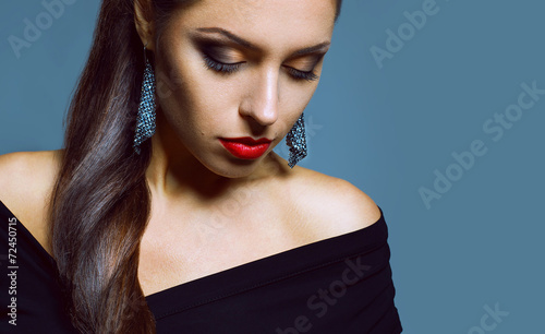 Fashion portrait of beautiful brunette in black dress posing in