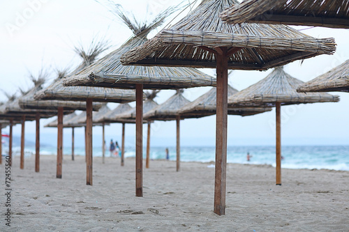 Fototapeta Naklejka Na Ścianę i Meble -  sandy beach sunbeds umbrellas sea