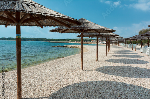 Fototapeta Naklejka Na Ścianę i Meble -  Parasols, beach Vir, Croatia