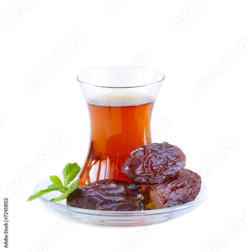 Turkish tea in traditional glass with sweet dates