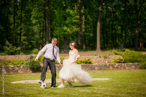 beautiful the couple in wedding day playing football