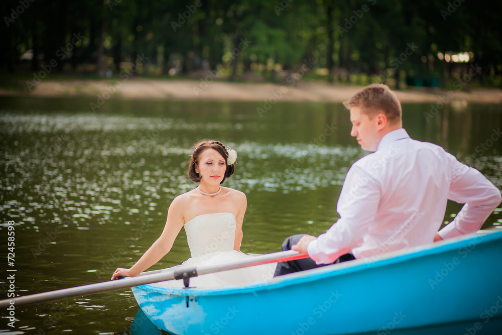 beautiful newlyweds in wedding day in a boat beautiful newlyweds in wedding day in a boat