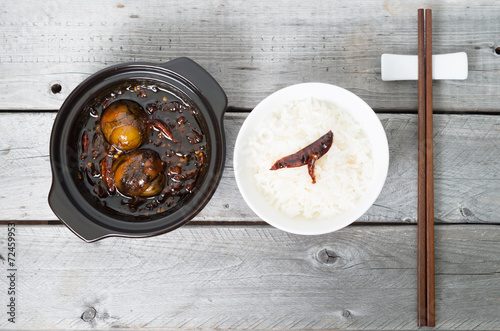 Caramelized balut - boiled developing duck embryo in a clay pot photo