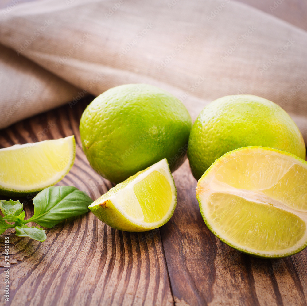 Fresh limes on wooden background. Fresh limes on wooden background.