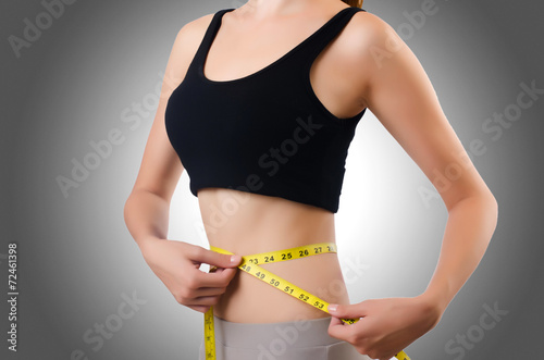 Young girl with centimeter in dieting concept