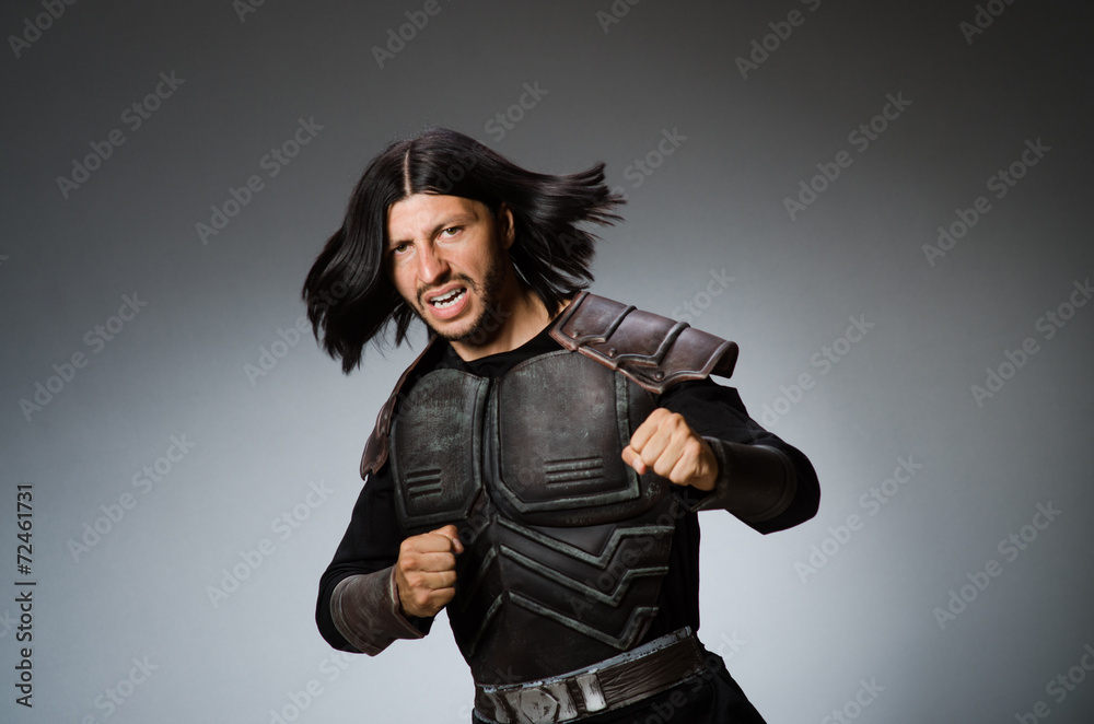 Naklejka premium Angry warrior against dark background