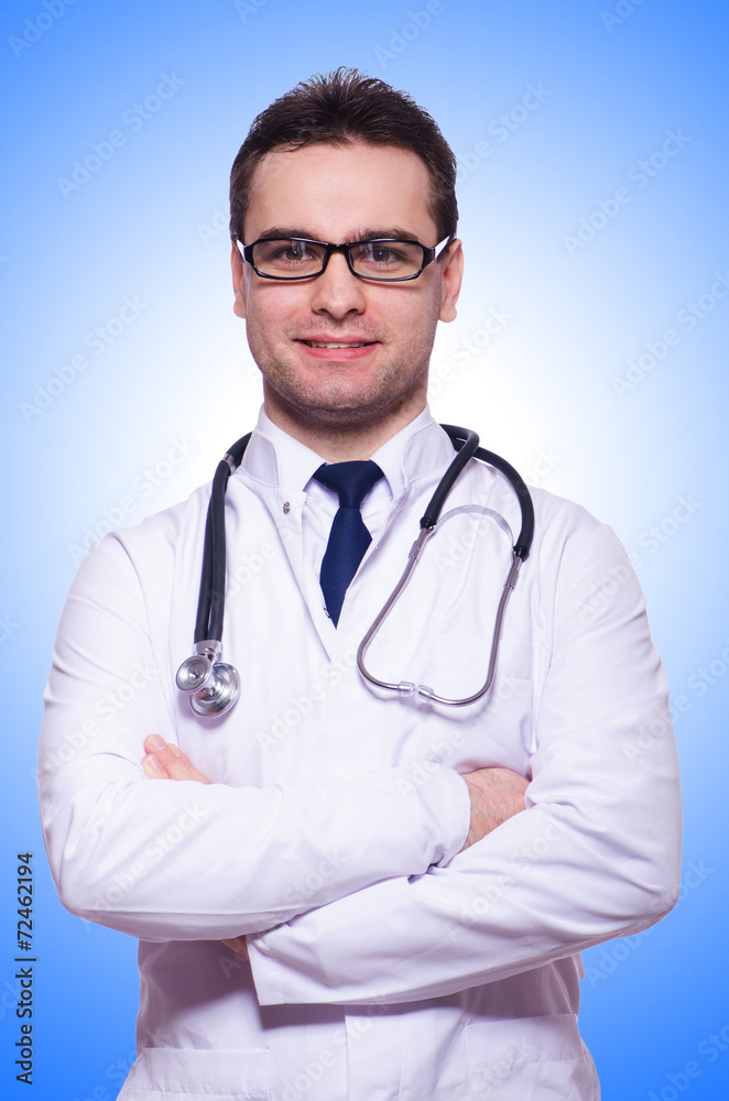 Fototapeta premium Young male doctor isolated on white
