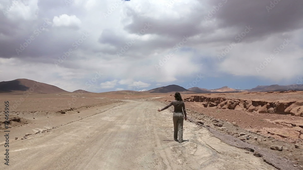 Woman catches the car at deserted road, Bolivia Woman catches the car at deserted road, Bolivia