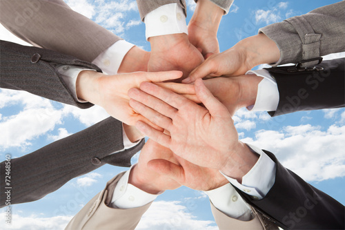 Businesspeople s Hands On Top Of Each Other Symbolizing Unity