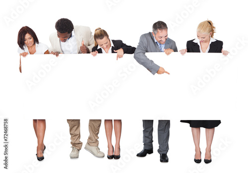 Multiethnic Business People Looking At Blank Billboard