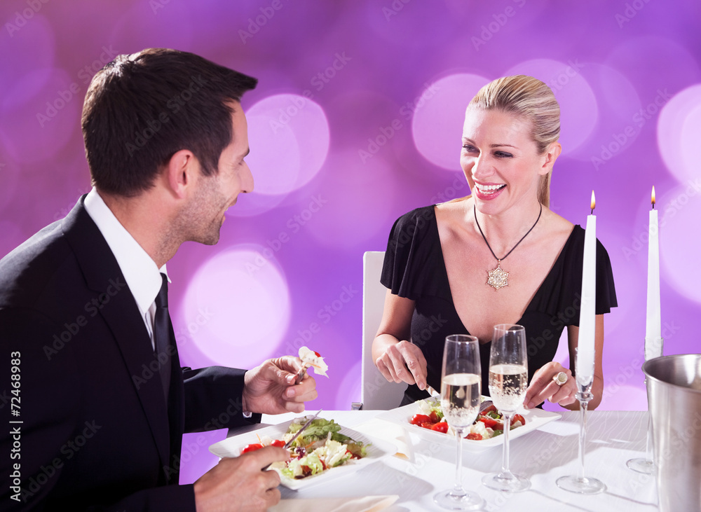 Couple Enjoying Candlelight Dinner At Restaurant Couple Enjoying Candlelight Dinner At Restaurant