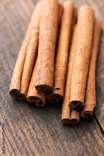 Cinnamon sticks on rustic wooden table close up