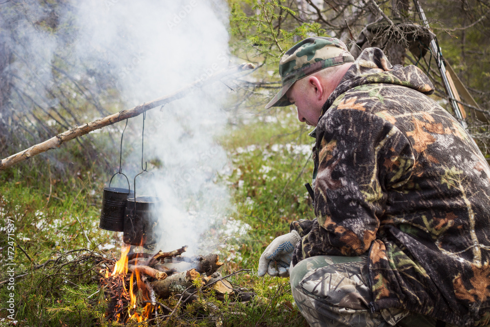 Huntsman has been cooking over a campfire Huntsman has been cooking over a campfire