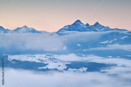 Alps in morning winter fog