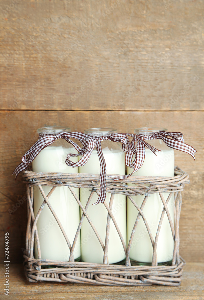 Bottles of tasty milk on wooden background Bottles of tasty milk on wooden background