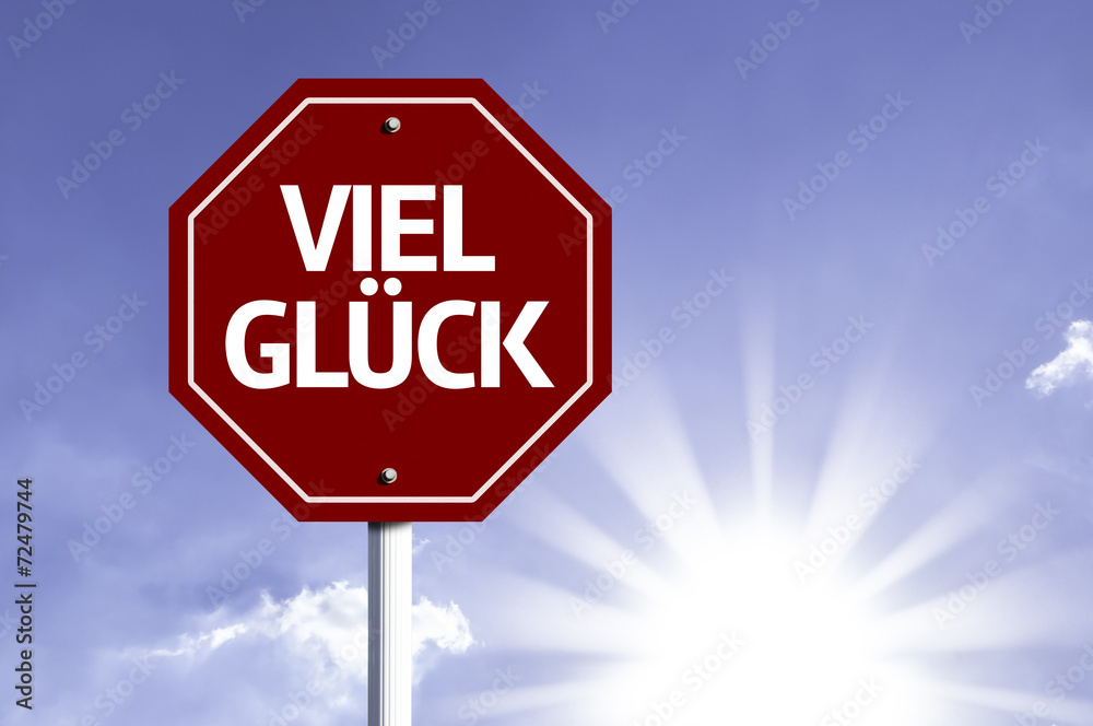 Good Luck (In German) written on red road sign Good Luck (In German) written on red road sign