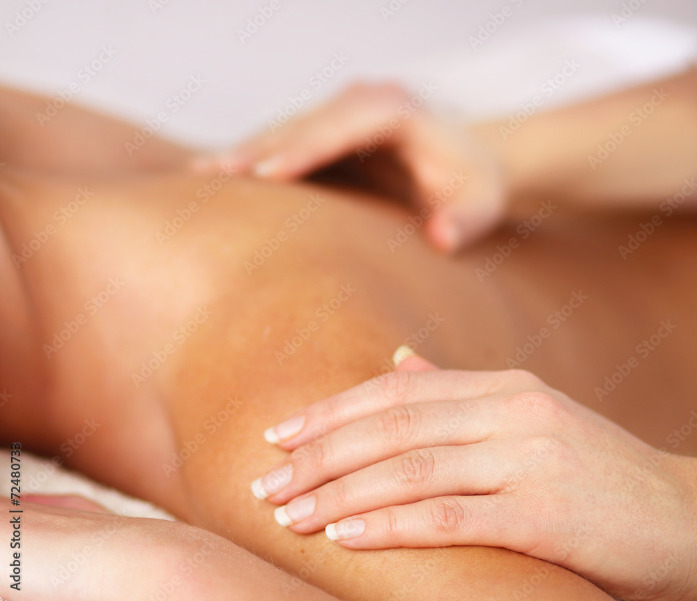 Closeup of an attractive young woman receiving massage