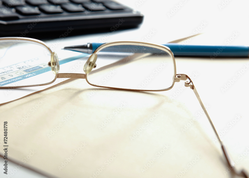 Calculator , folder with paper, pen and glasses Calculator , folder with paper, pen and glasses