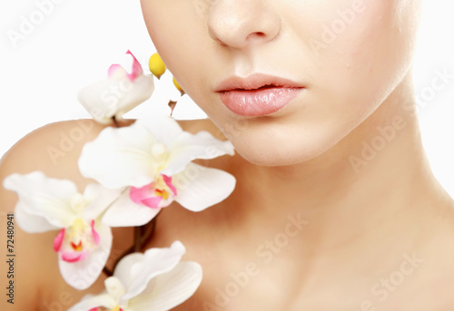 A young woman with orchid, isolated on white background