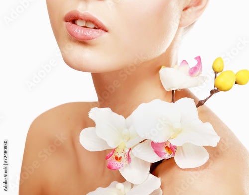 A young woman with orchid  isolated on white background