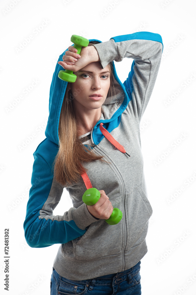 The girl with dumbbells on a white background The girl with dumbbells on a white background