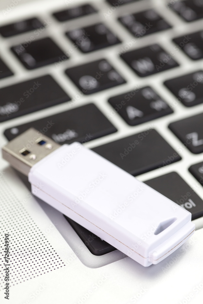 USB flash drive on a computer notebook USB flash drive on a computer notebook
